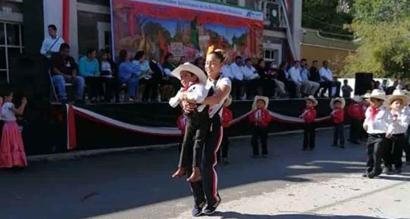 Maestra ayuda a bailar a niño con discapacidad en desfile