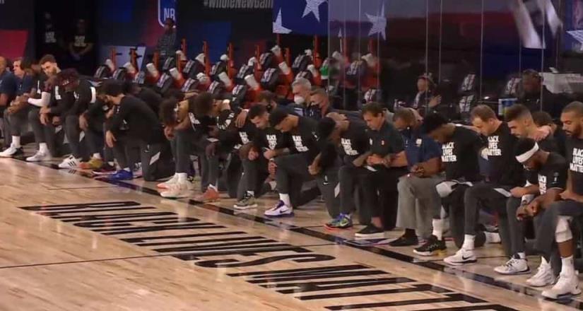 Jugadores se arrodillan durante el Himno en el regreso de la NBA