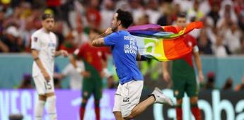 Entra corriendo un hombre con la bandera LGTB en  medio de un partido en el estadio de Qatar